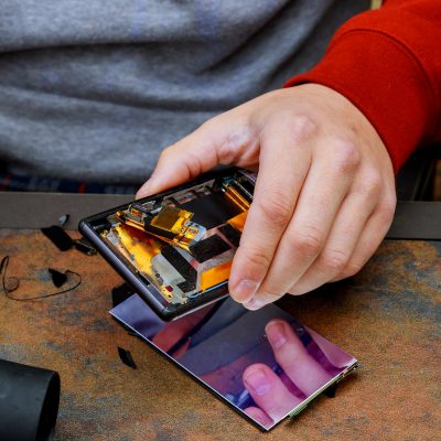 Closeup Fixing Damaged Phone showing process of mobile phone repair