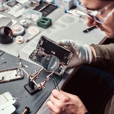 electronic-technician-repair-damaged-smartphone-in-the-workshop-1.jpg