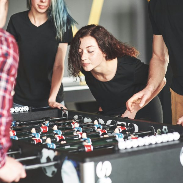 Friends together play board games, table football