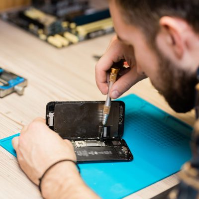 professional-gadget-repair-service-master-fixing-tiny-details-with-screwdriver-e1621920413975.jpg